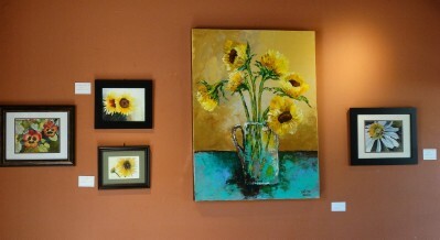 Claudia's charming flower "portraits" compliment a large acrylic painting.